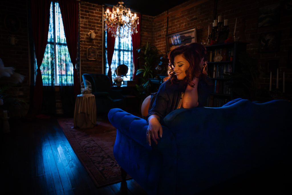 Client photographed in the luxurious Library set at Bohemian Visions boudoir studio in Richmond, Virginia.